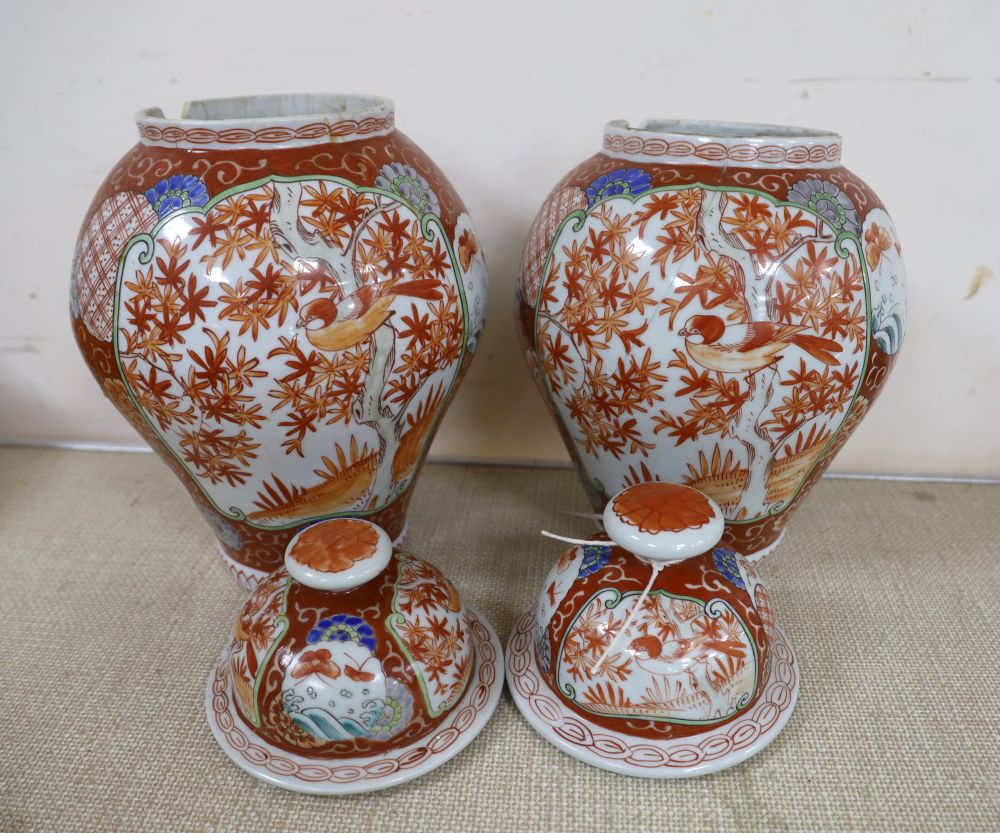 A near pair of Japanese porcelain lidded vases